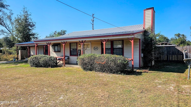 view of front of house featuring a front yard and a porch