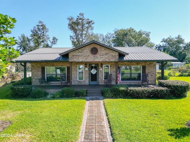 view of front of property with covered porch and a front yard