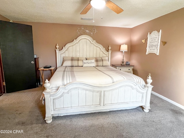 bedroom featuring ceiling fan, carpet, and a textured ceiling