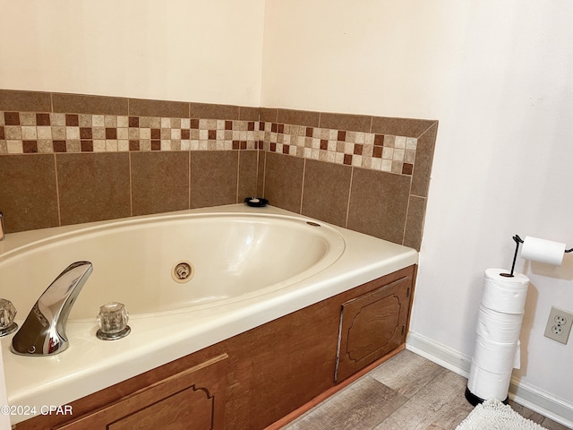 bathroom featuring hardwood / wood-style flooring and a bathtub