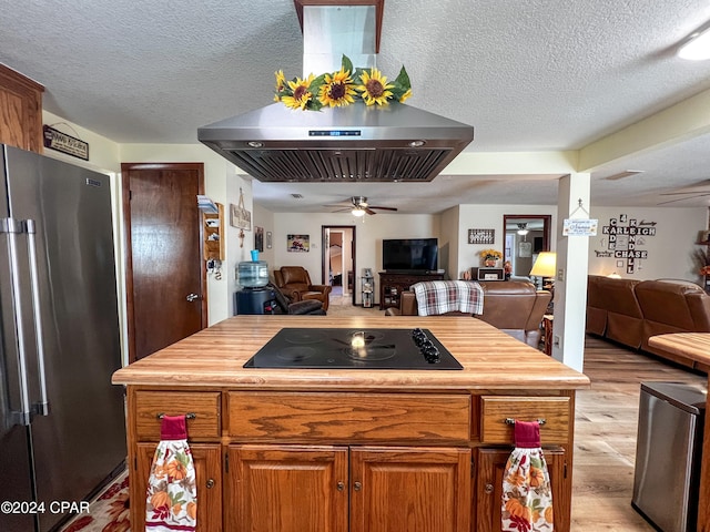 kitchen featuring high end refrigerator, ceiling fan, black electric cooktop, a textured ceiling, and light hardwood / wood-style floors