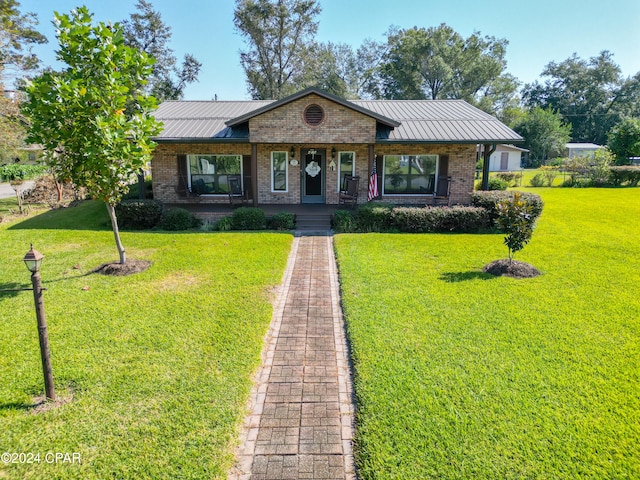 single story home with a front yard and a porch