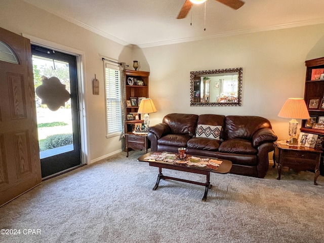 carpeted living room featuring ceiling fan and ornamental molding