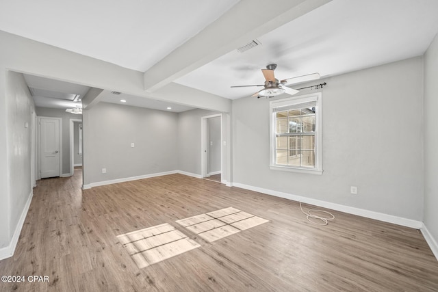 unfurnished room featuring beamed ceiling, ceiling fan, and light hardwood / wood-style flooring