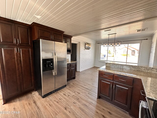 kitchen with stainless steel appliances, sink, hanging light fixtures, and plenty of natural light