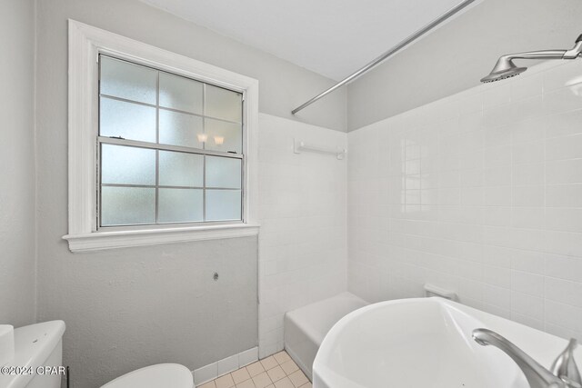 bathroom featuring toilet and tile patterned flooring