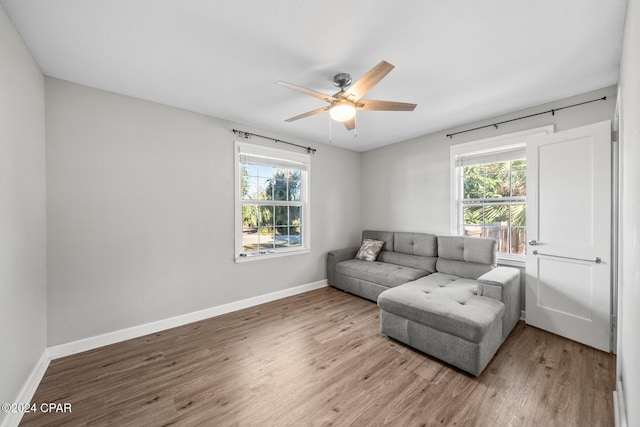 living room with hardwood / wood-style floors and ceiling fan