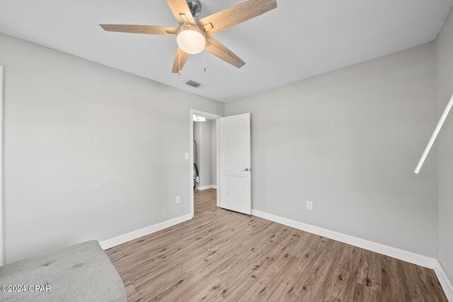 unfurnished bedroom featuring ceiling fan and light wood-type flooring