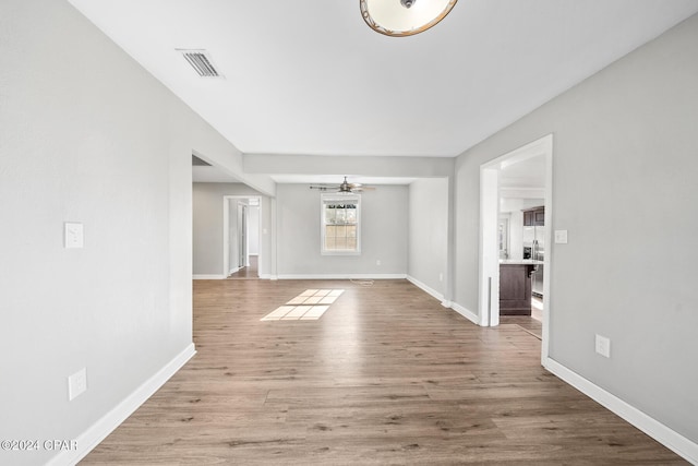 unfurnished living room with light wood-type flooring and ceiling fan