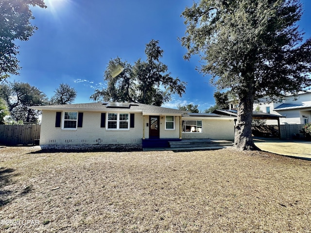 ranch-style home featuring a carport