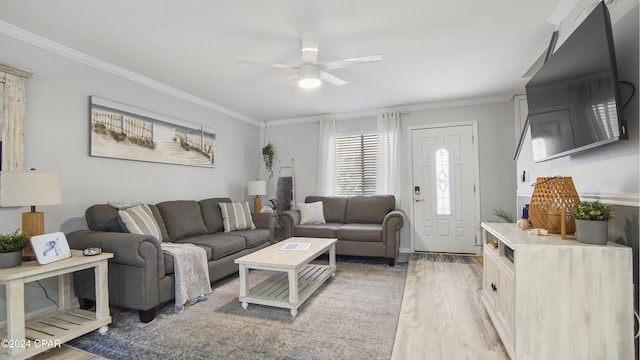 living room featuring hardwood / wood-style flooring, ornamental molding, and ceiling fan