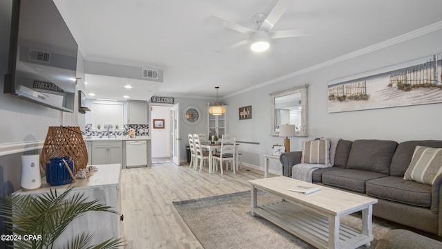 living room with light hardwood / wood-style flooring, ceiling fan, and ornamental molding