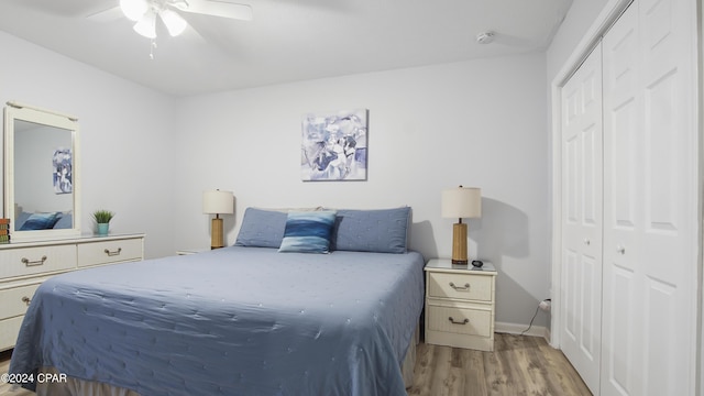 bedroom with ceiling fan, light hardwood / wood-style floors, and a closet