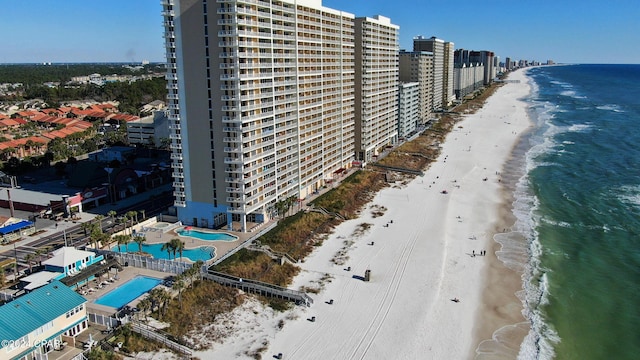 drone / aerial view featuring a water view and a beach view