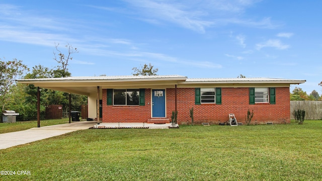 ranch-style house featuring a carport and a front lawn