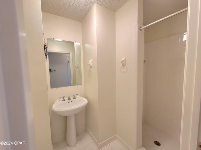 17680 Margaret St, Blountstown, FL 32424 - bathroom featuring a textured ceiling, baseboards, and a stall shower