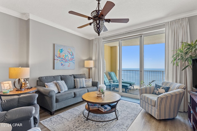 living room featuring ornamental molding, a textured ceiling, hardwood / wood-style floors, and ceiling fan