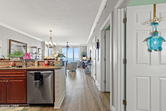 kitchen featuring ornamental molding, dishwasher, a textured ceiling, and light wood-type flooring