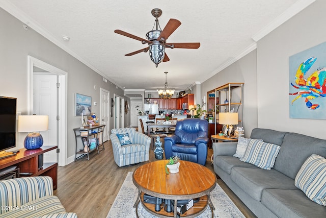 living room featuring light hardwood / wood-style floors, crown molding, a textured ceiling, and ceiling fan with notable chandelier