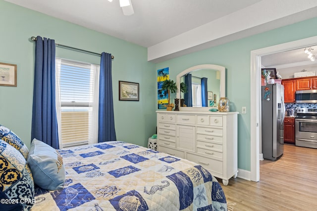 bedroom featuring light hardwood / wood-style floors, ceiling fan, and stainless steel fridge with ice dispenser