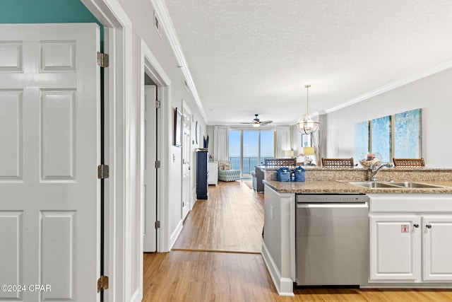 kitchen with stainless steel dishwasher, crown molding, white cabinetry, and a textured ceiling