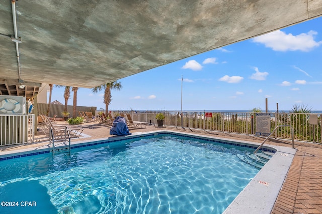 view of swimming pool with a water view