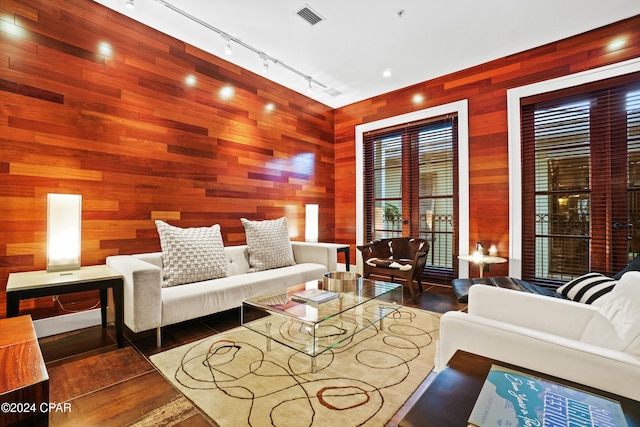 living room featuring french doors and wood walls