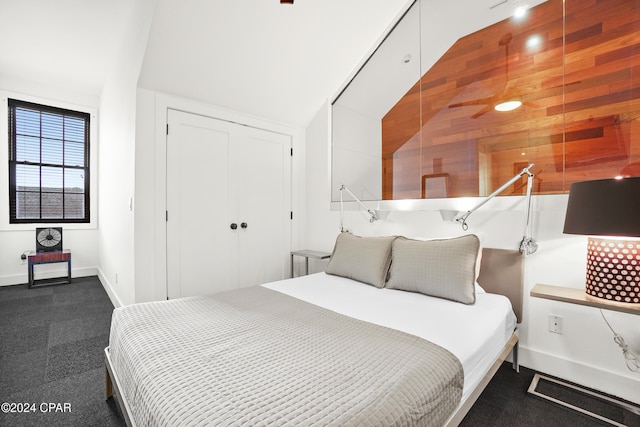 bedroom featuring a closet, wood walls, and track lighting