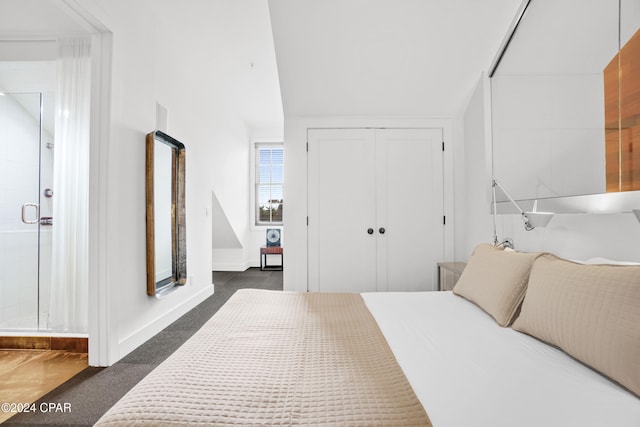 bedroom with dark colored carpet and a closet