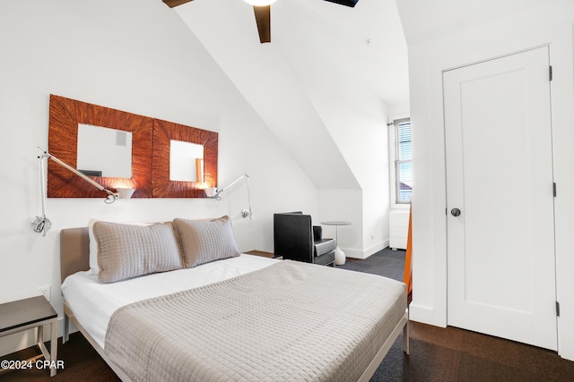 bedroom featuring lofted ceiling and carpet