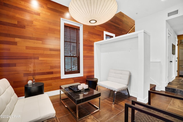 unfurnished dining area featuring wooden walls