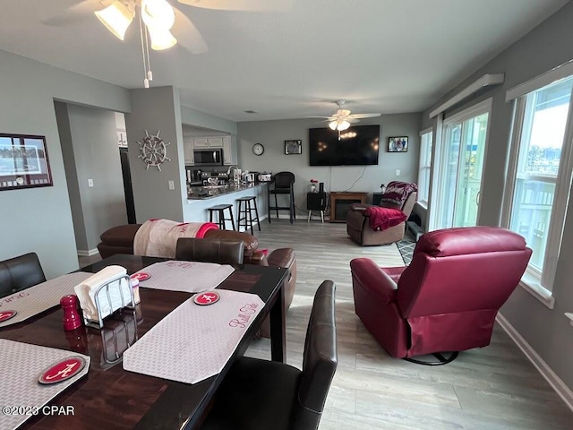 living room with hardwood / wood-style floors, sink, and ceiling fan