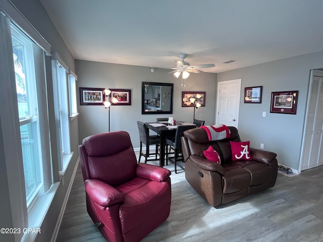 living room with hardwood / wood-style floors and ceiling fan