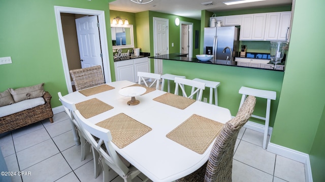 dining area with sink and light tile patterned flooring