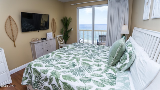 bedroom with access to exterior and dark wood-type flooring