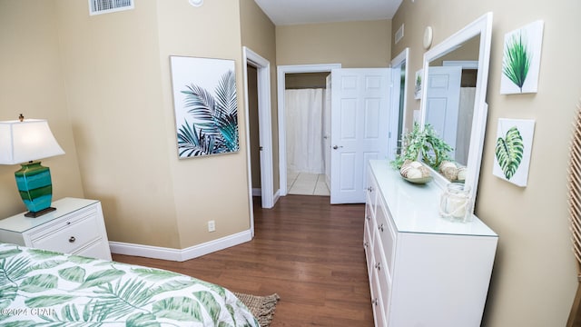 bedroom with dark hardwood / wood-style floors