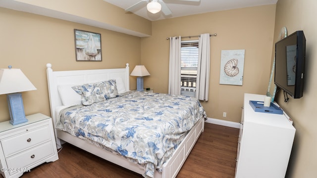 bedroom with dark hardwood / wood-style flooring and ceiling fan