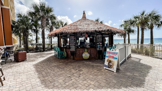 view of patio / terrace with a water view and a gazebo