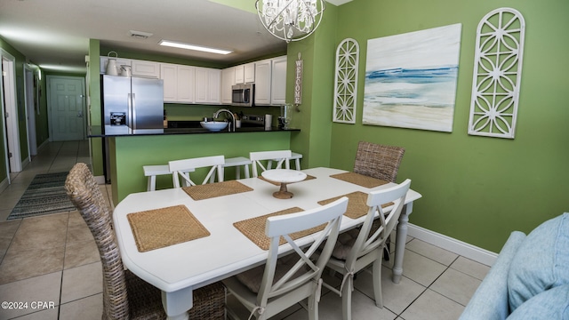 dining area featuring an inviting chandelier and light tile patterned floors