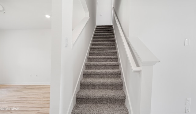 stairs with hardwood / wood-style flooring