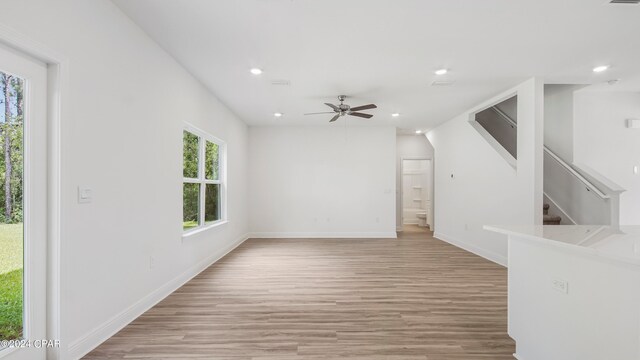 unfurnished living room with ceiling fan and light hardwood / wood-style flooring