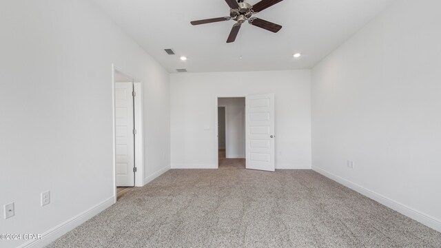 unfurnished room featuring light carpet and ceiling fan