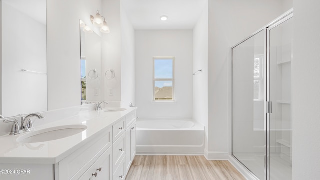 bathroom with vanity, plus walk in shower, and wood-type flooring