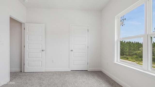 unfurnished bedroom featuring light carpet