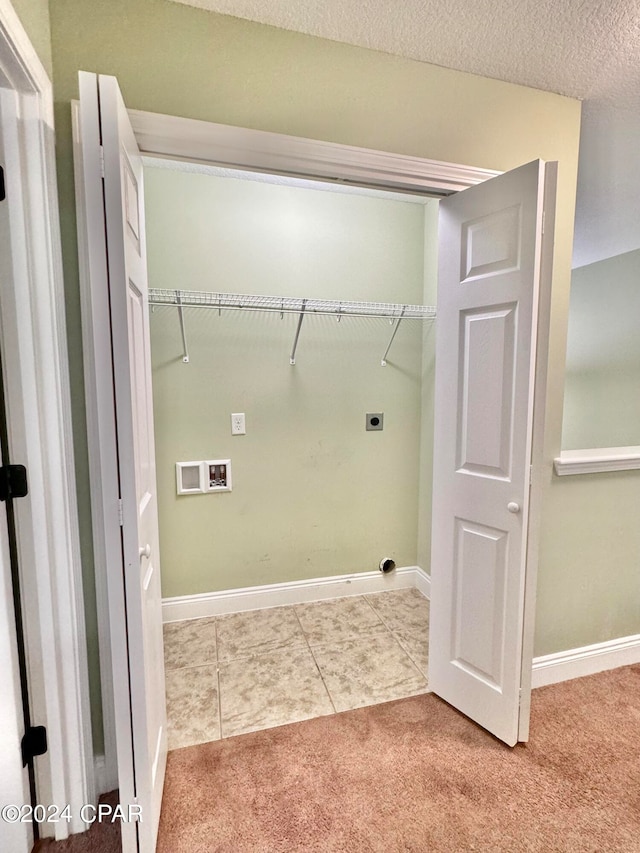 clothes washing area featuring hookup for an electric dryer, carpet, a textured ceiling, and hookup for a washing machine