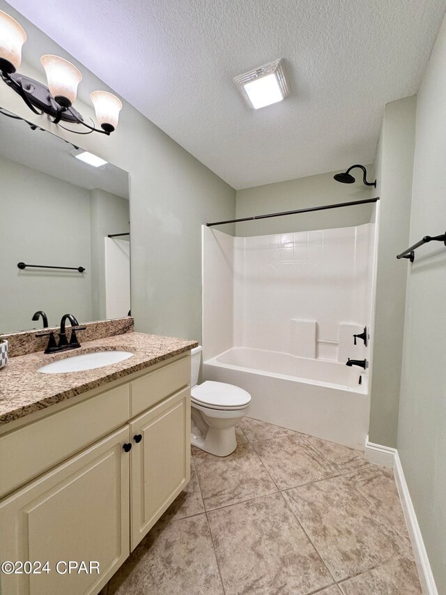 full bathroom featuring tile patterned floors, tub / shower combination, vanity, a textured ceiling, and toilet