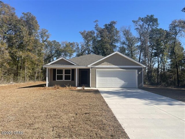 view of front of home with a garage and a yard