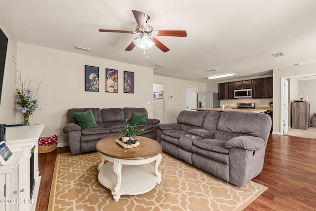 living room featuring hardwood / wood-style flooring and ceiling fan