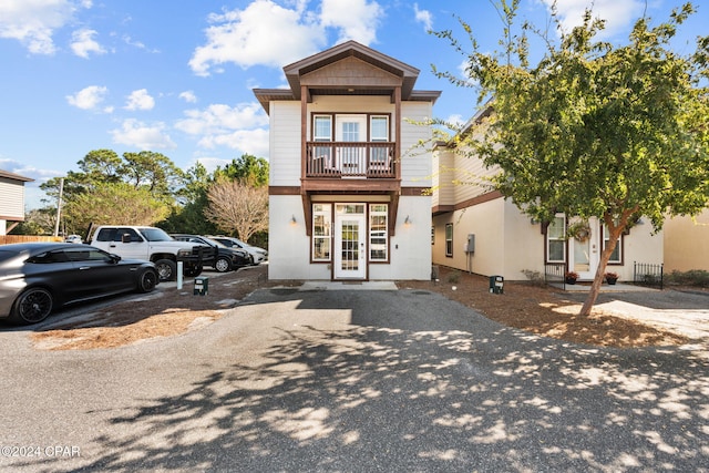 view of front of house featuring french doors and a balcony