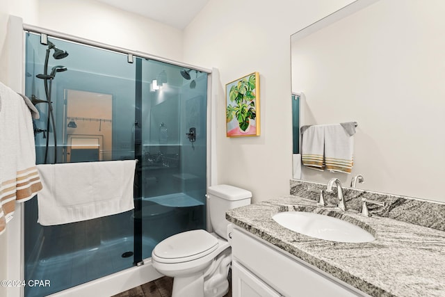 bathroom featuring vanity, toilet, hardwood / wood-style flooring, and an enclosed shower